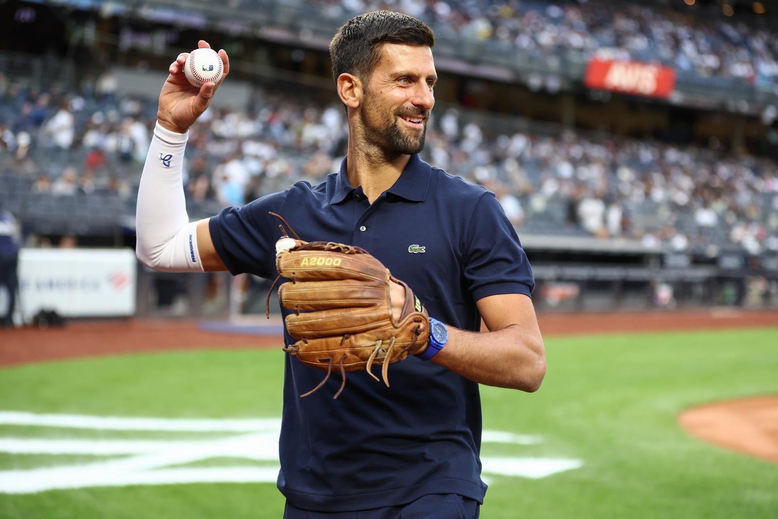 Aug 21, 2025; Bronx, New York, USA;  Professional tennis player Novak Djokovic prepares to throw out the first pitch prior to the game between the Boston Red Sox and the New York Yankees at Yankee Stadium. Mandatory Credit: Wendell Cruz-Imagn Images/Sipa USA 
  Photo: Imagn Images/SIPA USA