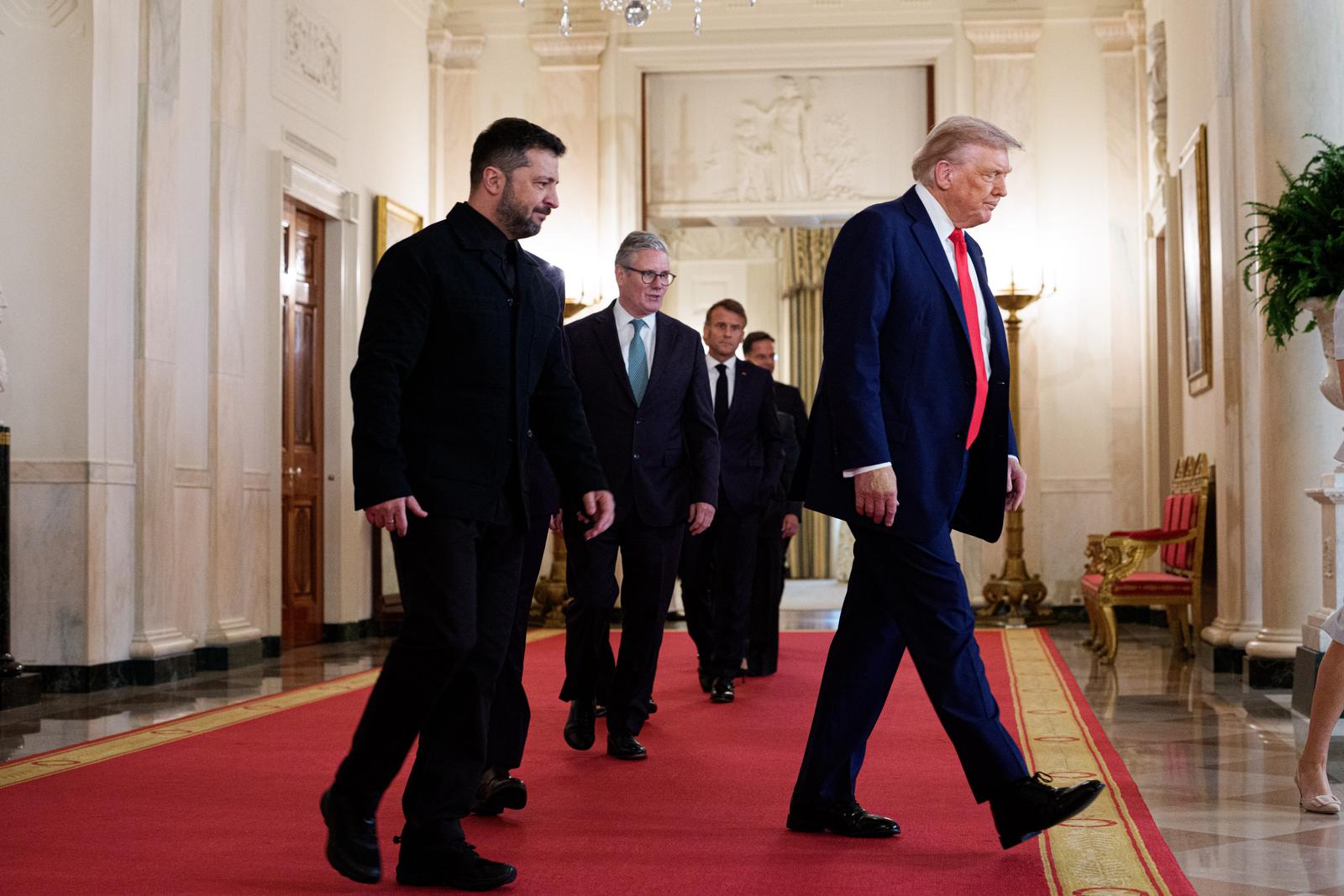 United States President Donald J Trump leads President Volodymyr Zelenskyy of Ukraine, Chancellor Friedrich Merz of Germany Mark Rutte, Secretary General of the North Atlantic Treaty Organization (NATO), and President Emmanuel Macron of France, in Cross Hall of the White House in Washington, DC, USA, on Monday, August 18, 2025. European Leaders are at the White House in support of President Zelenskyy following President Trumps meeting with President Vladimir Putin of Russia in Anchorage, Alaska, USA, on Friday, August 15, 2025. Credit: Aaron Schwartz / Pool via CNP