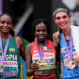 Gold medalist Kenya's Peres Jepchirchir, center, poses with silver medalist Ethiopia's Tigst Assefa and bronze medalist Uruguay's Julia Paternainafter finishing the women's marathon at the World Athletics Championships in Tokyo, Sunday, Sept. 14, 2025. (AP Photo/Matthias Schrader) Japan Athletics Worlds