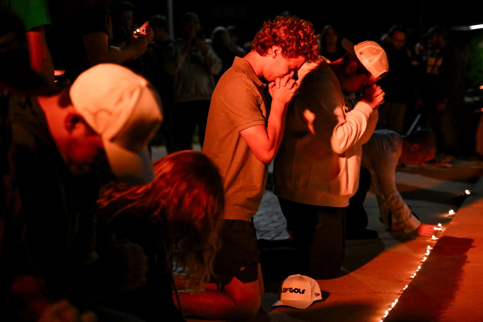 MSU freshman Bryce Denne prays after leaving a candle below a photo of conservative activist Charlie Kirk during a vigil on Thursday, Sept. 11, 2025, outside Wells Hall on the Michigan State University campus in East Lansing. Kirk was shot and killed Sept. 10 while speaking on a Utah college campus. The gathering was organized by MSU's Turning Point chapter and the Michigan State University College Republicans organization. (Photo by Nick King/Lansing State Journal / USA TODAY NETWORK via Imagn Images/Sipa USA) Photo: USA TODAY/SIPA USA