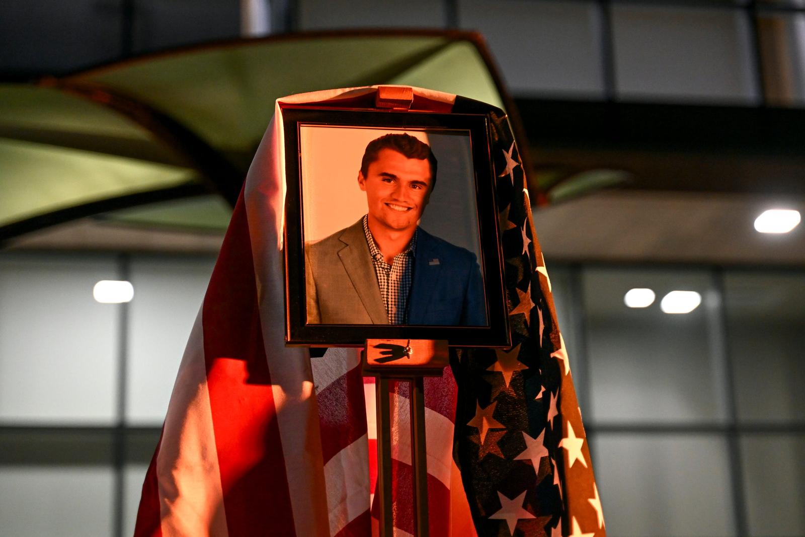 A photo of conservative activist Charlie Kirk is draped with the U.S. flag during a during a vigil on Thursday, Sept. 11, 2025, outside Wells Hall on the Michigan State University campus in East Lansing. Kirk was shot and killed Sept. 10 while speaking on a Utah college campus. The gathering was organized by MSU's Turning Point chapter and the Michigan State University College Republicans organization. (Photo by Nick King/Lansing State Journal / USA TODAY NETWORK via Imagn Images/Sipa USA) Photo: USA TODAY/SIPA USA