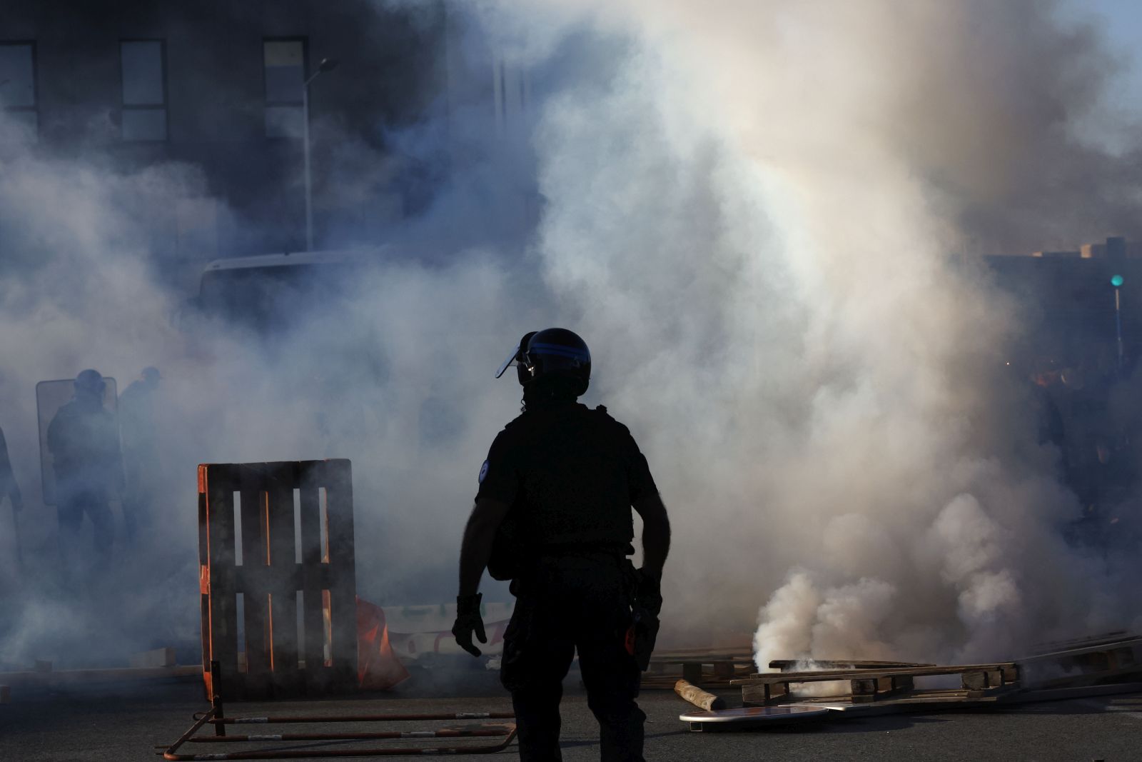 epa12366434 A Police officer walks as protesters burn wooden pallets while blocking streets during a call for action by 'Bloquons tout' (Block everything) collective in Montpellier, France, 10 September 2025. In a protest against the outgoing government's austerity budget, an online collective called 'Bloquons Tout' has called for everyone to block the entire country on 10 September with symbolic actions.  EPA/GUILLAUME HORCAJUELO