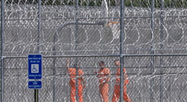epa12365739 Detainees behind concertina wire inside the Folkston ICE Processing Center and D. Ray James Correctional Facility in Folkston, Georgia, USA, 09 September 2025. 300 South Koreans were among 475 arrested during a US Immigration and Customs Enforcement raid at a construction site for an electric vehicle battery plant being built by a Hyundai Motor Group-LG Energy Solution in Ellabell, Georgia, 04 September 2025. South Korean officials are arranging a repatriation charter flight for the detainees.  EPA/ERIK S. LESSER
