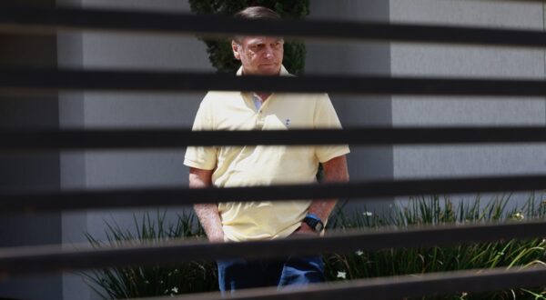 epa12349669 Brazil's former president Jair Bolsonaro walks at his residence in Brasilia, Brazil, 03 September 2025. Bolsonaro's defense team denied before the Supreme Court that the former Brazilian president participated in a coup plot and reduced the prosecution's accusation to 'suppositions' in a session that has left the trial ready for sentencing.  EPA/SEBASTIAO MOREIRA
