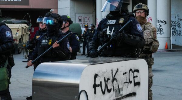 EDITOR'S NOTE : Image depicts profanity Heavily armed federal agents, including members of U.S. Customs and Border Protection and Homeland Security, stand guard near a block marked with black spray-painted graffiti reading fuck ICE during an anti-ICE demonstration. Demonstrators staged a protest as part of a citywide action against U.S. Immigration and Customs Enforcement (ICE), where protesters called for the end of deportations, the shutdown of detention centers, and protection for migrant communities across the United States. (Photo by Alvaro Diaz / SOPA Images/Sipa USA) Photo: SOPA Images/SIPA USA
