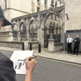An artist draws the scene, where two security guards are standing next to the wall where a new artwork by artist Banksy has already been covered up at the Royal Courts of Justice in London. The artwork shows a judge attacking a protester with a gavel is on an external wall of the Queen's Building, part of the Royal Courts of Justice complex, and has been concealed by large sheets of black plastic and two metal barriers. Issue date: Monday September 8, 2025. Photo: Callum Parke/PRESS ASSOCIATION
