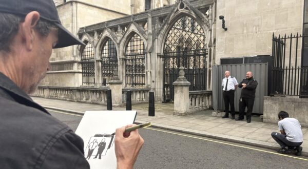 An artist draws the scene, where two security guards are standing next to the wall where a new artwork by artist Banksy has already been covered up at the Royal Courts of Justice in London. The artwork shows a judge attacking a protester with a gavel is on an external wall of the Queen's Building, part of the Royal Courts of Justice complex, and has been concealed by large sheets of black plastic and two metal barriers. Issue date: Monday September 8, 2025. Photo: Callum Parke/PRESS ASSOCIATION