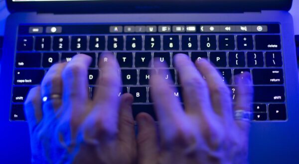 A man uses a computer keyboard on Monday, Oct. 9, 2023 in this photo illustration. A Labrador man has lost his bid for a long-sought public hearing about his allegedly illegal detainment by police in 2015 at a mental health hospital for a post he made on social media. THE CANADIAN PRESS/Graeme Roy Photo: Graeme Roy/PRESS ASSOCIATION
