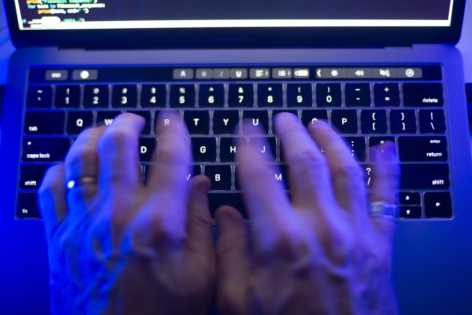 A man uses a computer keyboard on Monday, Oct. 9, 2023 in this photo illustration. A Labrador man has lost his bid for a long-sought public hearing about his allegedly illegal detainment by police in 2015 at a mental health hospital for a post he made on social media. THE CANADIAN PRESS/Graeme Roy Photo: Graeme Roy/PRESS ASSOCIATION