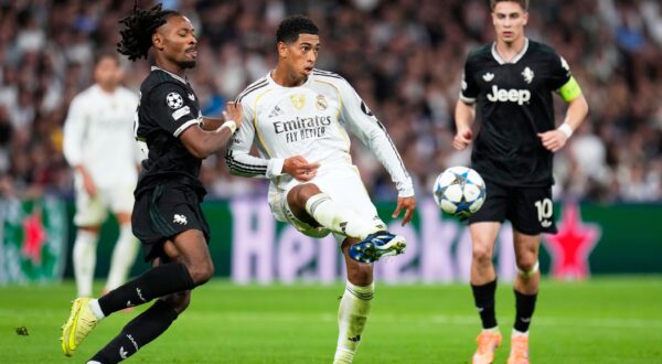 Juventus' Khephren Thuram, left, challenges Real Madrid's Jude Bellingham during the Champions League opening phase soccer match between Real Madrid and Juventus in Madrid, Spain, Wednesday, Oct. 22, 2025. (AP Photo/Manu Fernandez) Spain Soccer Champions League