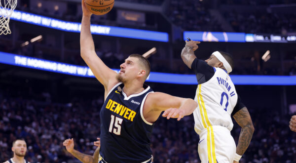 Denver Nuggets' Nikola Jokic (15) out rebounds Golden State Warriors' Gary Payton II (0) during the first half of an NBA basketball game in San Francisco on Thursday, Oct. 23, 2025. (Scott Strazzante/San Francisco Chronicle via AP)