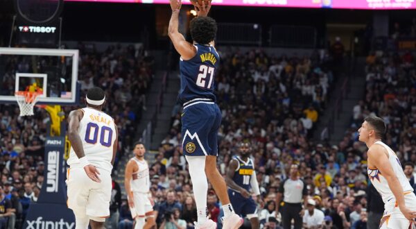 Denver Nuggets guard Jamal Murray, center, shoots a 3-point basket as Phoenix Suns forward Royce O'Neale, left, and guard Grayson Allen, right, look on as time runs out in the first quarter of an NBA basketball game Saturday, Oct. 25, 2025, in Denver. (AP Photo/David Zalubowski) Suns Nuggets Basketball