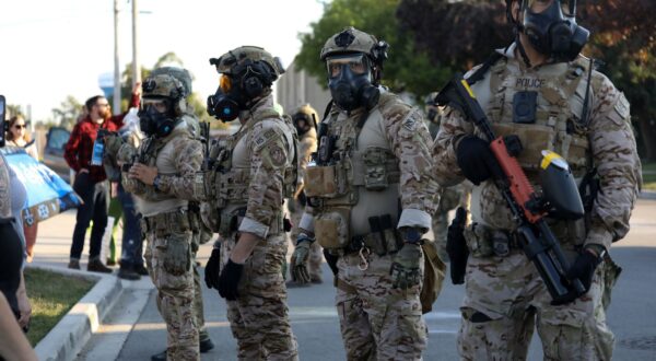 epa12372469 US Immigration and Customs Enforcement (ICE) personnel wearing gas masks stand guard as people take part in the ICE Out of Chicago protest in Chicago, Illinois, USA, 12 September 2025 (issued 13 September 2025). US Immigration and Customs Enforcement (ICE) has launched operations in Chicago to target undocumented immigrants despite opposition from the Governor of Illinois, JB Pritzker, and the Mayor of Chicago, Brandon Johnson.  EPA/ABLE URIBE