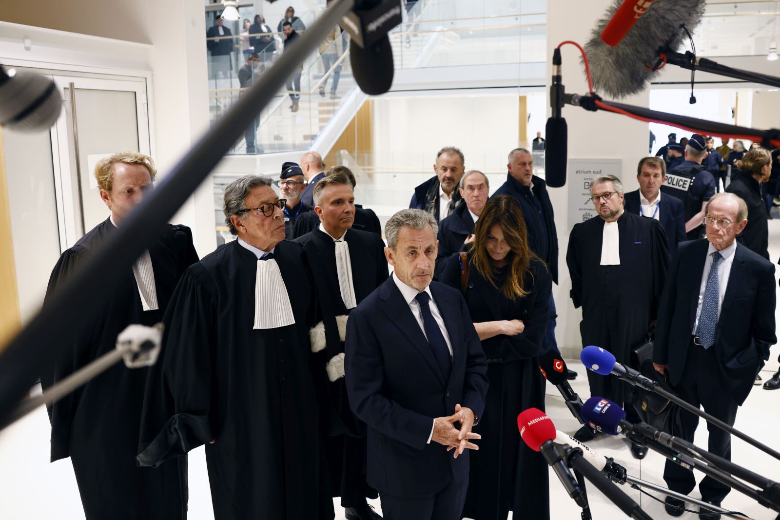 epa12404541 Former French president Nicolas Sarkozy (C) speaks to the press as he leaves the courthouse in Paris, France, 25 September 2025. Sarkozy and twelve others, including three former ministers, stood trial for criminal conspiracy to receive funds for the 2007 presidential campaign from the regime of late Libyan leader Muammar Gaddafi, and he has now been sentenced to five years in jail for his role in the case involving funds from Gaddafi. Sarkozy has been convicted twice in separate cases since leaving office in 2012.  EPA/YOAN VALAT
