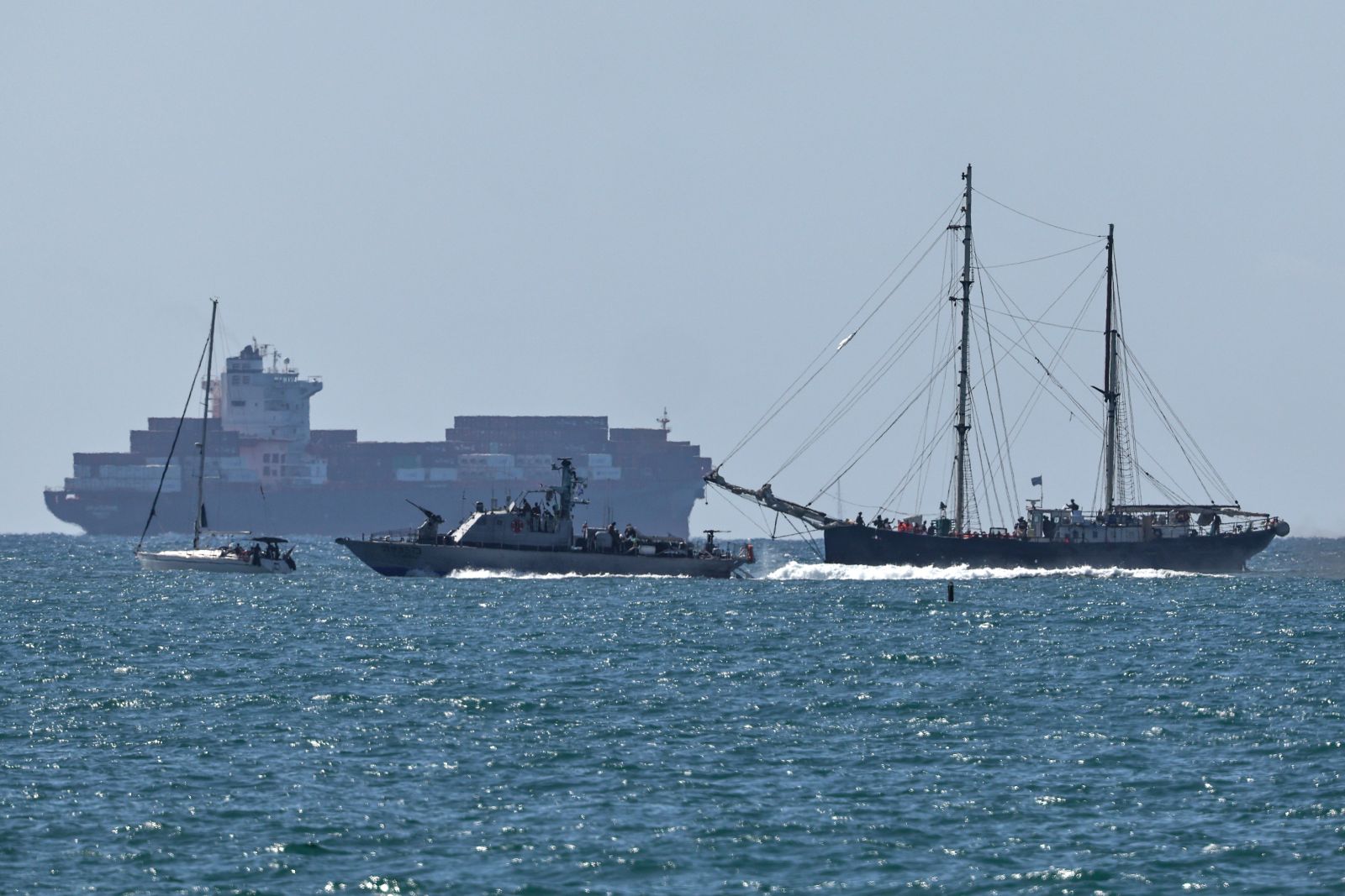 epa12423880 A vessel of the Global Sumud Flotilla (L) arrives at Ashdod port, Israel, 02 October 2025, after being intercepted by the Israeli authorities while carrying aid to Gaza. Israel's Foreign Ministry announced that several vessels that form part of the Global Sumud Flotilla (GSF) had been stopped and that those aboard were being transferred to an Israeli port.  EPA/ATEF SAFADI