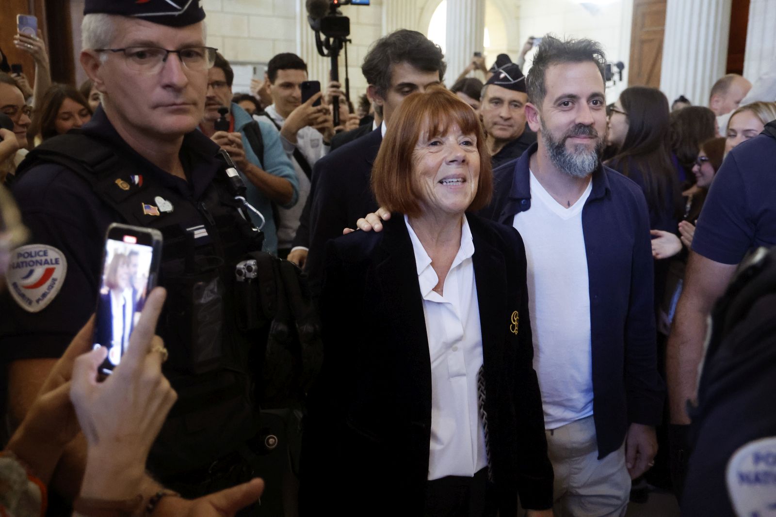 epa12439825 Gisele Pelicot (L) accompanied by her son Florian Pelicot (R) leaves the Gard criminal court, in Nimes, France, 08 October 2025. An appeal trial involving one of the defendants sentenced in the mass rapes committed against her will be heard by the court from 06 through 09 October.  EPA/GUILLAUME HORCAJUELO