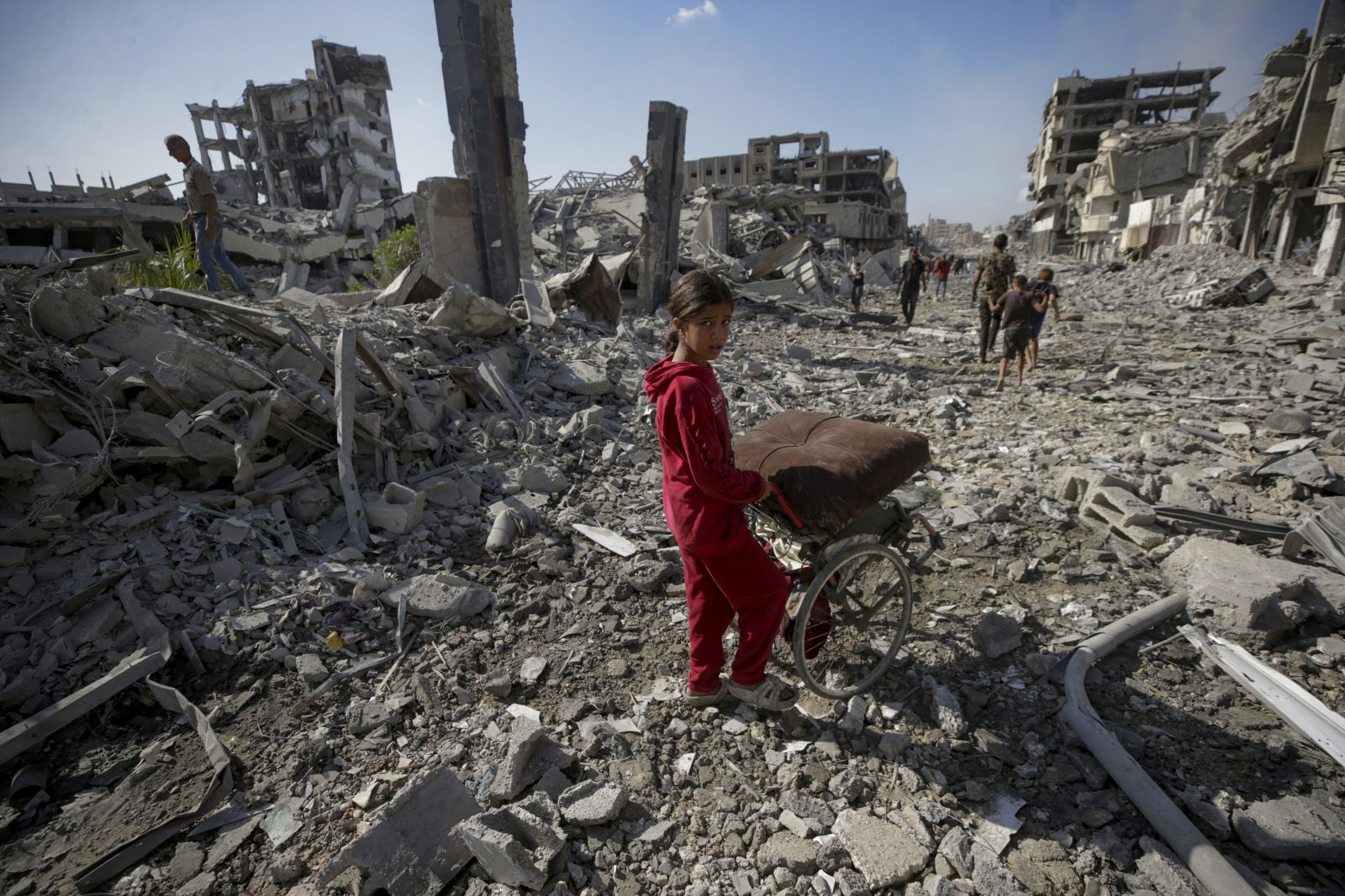 epa12444382 Palestinians walk along a street amid the rubble of destroyed buildings during a ceasefire between Israel and Hamas under the first phase of the Gaza peace plan, in Gaza City, Gaza Strip, 10 October 2025. Prime Minister Benjamin Netanyahu's office announced on 09 October that the Israeli government had approved the Gaza ceasefire and hostage release plan.  EPA/MOHAMMED SABER