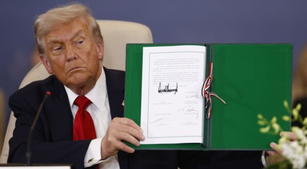epa12451406 US President Donald Trump shows a signed document at the Gaza Peace Summit in Sharm El-Sheikh, Egypt, 13 October 2025. US President Donald Trump alongside Egypt's President Abdel Fattah al-Sisi with leaders from more than 20 countries attend the summit in Sharm El-Sheikh. The first phase of Gaza peace plan between Israel and Hamas involves the release of Israeli hostages and Palestinian prisoners, the partial withdrawal of Israeli forces, and the delivery of humanitarian aid to Gaza.  EPA/YOAN VALAT / POOL