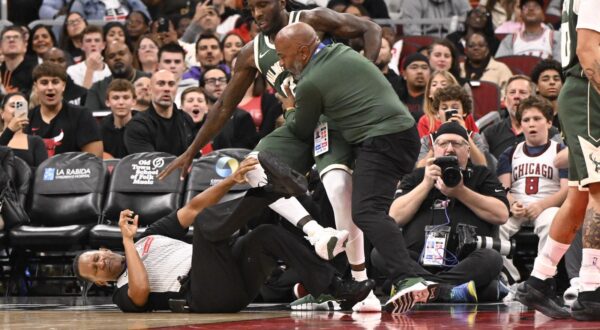 Oct 12, 2025; Chicago, Illinois, USA;  Official James Capers gets knocked down during a fight between Milwaukee Bucks forward Taurean Prince (12), left, and Chicago Bulls forward Dalen Terry (7), right, during the second half at the United Center. Mandatory Credit: Matt Marton-Imagn Images/Sipa USA Photo: Imagn Images/SIPA USA