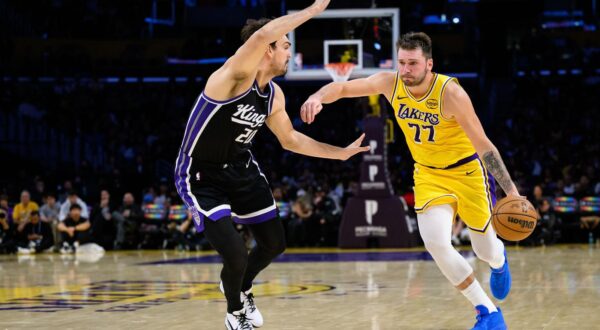 Oct 17, 2025; Los Angeles, California, USA; Los Angeles Lakers forward/guard Luka Doncic (77) drives the ball against Sacramento Kings forward/center Dario Saric (20) during the second half at Crypto.com Arena. Mandatory Credit: William Liang-Imagn Images/Sipa USA Photo: Imagn Images/SIPA USA