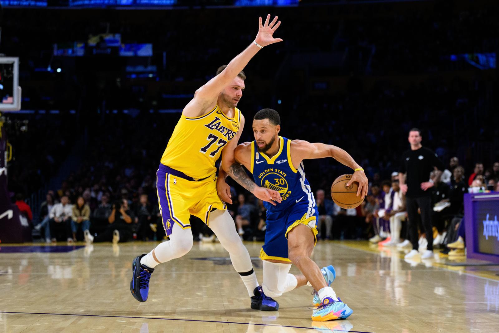 Oct 21, 2025; Los Angeles, California, USA; Golden State Warriors guard Stephen Curry (30) drives against Los Angeles Lakers guard Luka Doncic (77) during the second half at Crypto.com Arena. Mandatory Credit: William Liang-Imagn Images/Sipa USA Photo: Imagn Images/SIPA USA