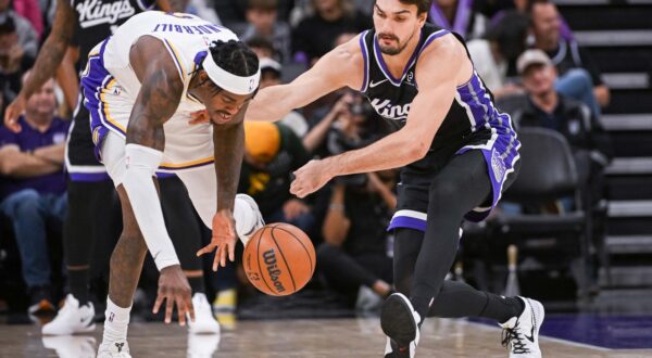 Oct 26, 2025; Sacramento, California, USA; Los Angeles Lakers forward Jarred Vanderbilt (2) and Sacramento Kings forward Dario Saric (20) fight for possession of the ball during the fourth quarter at Golden 1 Center. Mandatory Credit: Ed Szczepanski-Imagn Images/Sipa USA Photo: Imagn Images/SIPA USA