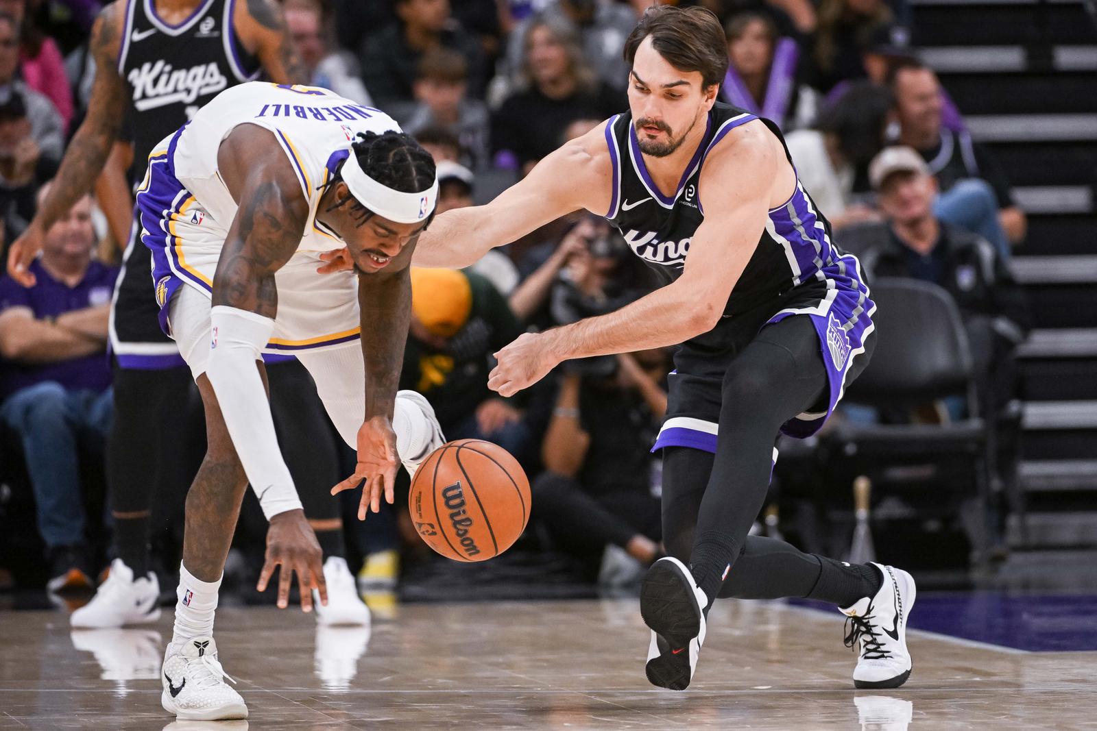Oct 26, 2025; Sacramento, California, USA; Los Angeles Lakers forward Jarred Vanderbilt (2) and Sacramento Kings forward Dario Saric (20) fight for possession of the ball during the fourth quarter at Golden 1 Center. Mandatory Credit: Ed Szczepanski-Imagn Images/Sipa USA Photo: Imagn Images/SIPA USA