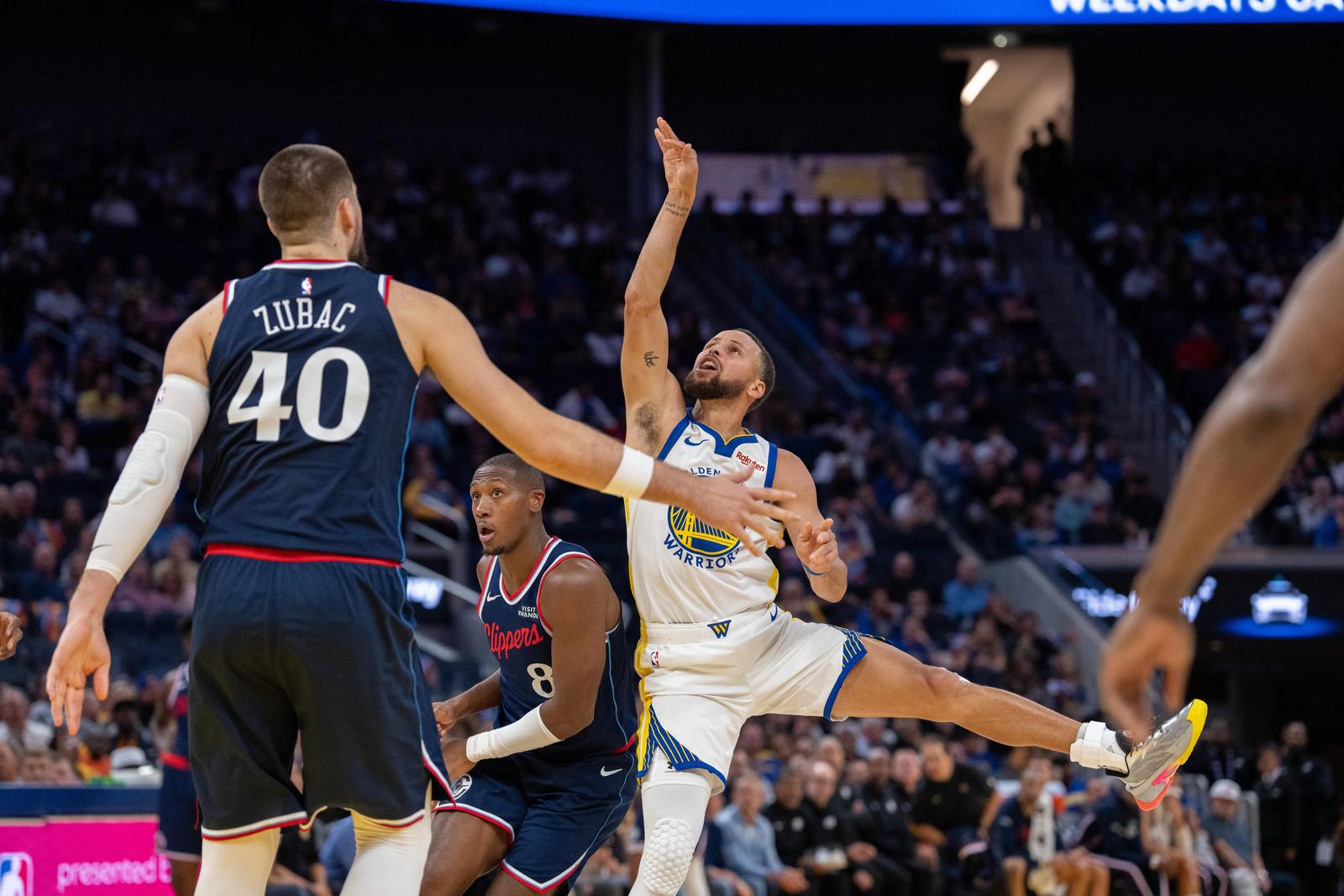 Oct 28, 2025; San Francisco, California, USA; Golden State Warriors guard Stephen Curry (30) shoots the basketball against LA Clippers guard Kris Dunn (8) and LA Clippers center Ivica Zubac (40) during the fourth quarter at Chase Center. Mandatory Credit: Neville E. Guard-Imagn Images/Sipa USA Photo: Imagn Images/SIPA USA