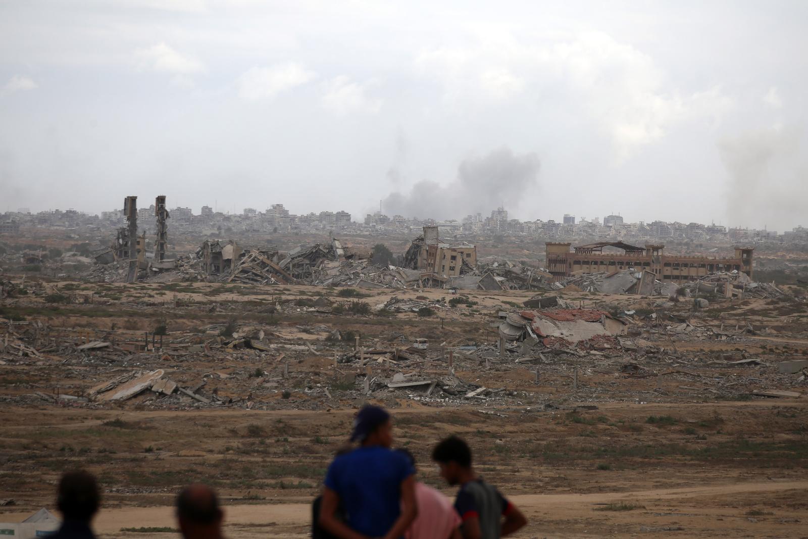 Palestinians observe widespread destruction as smoke rises billows following Israeli bombardment on the Gaza Strip as seen from northwest of Nuseirat refugee camp in Gaza, on Thursday on October 9, 2025. On the same day, Israel and Hamas reached a deal to release the remaining living hostagesa major step toward ending a war that has claimed tens of thousands of lives and triggered a humanitarian catastrophe. Photo by Hassan Al-Jadi/UPI Photo via Newscom Photo: Hassan Al-Jadi/NEWSCOM