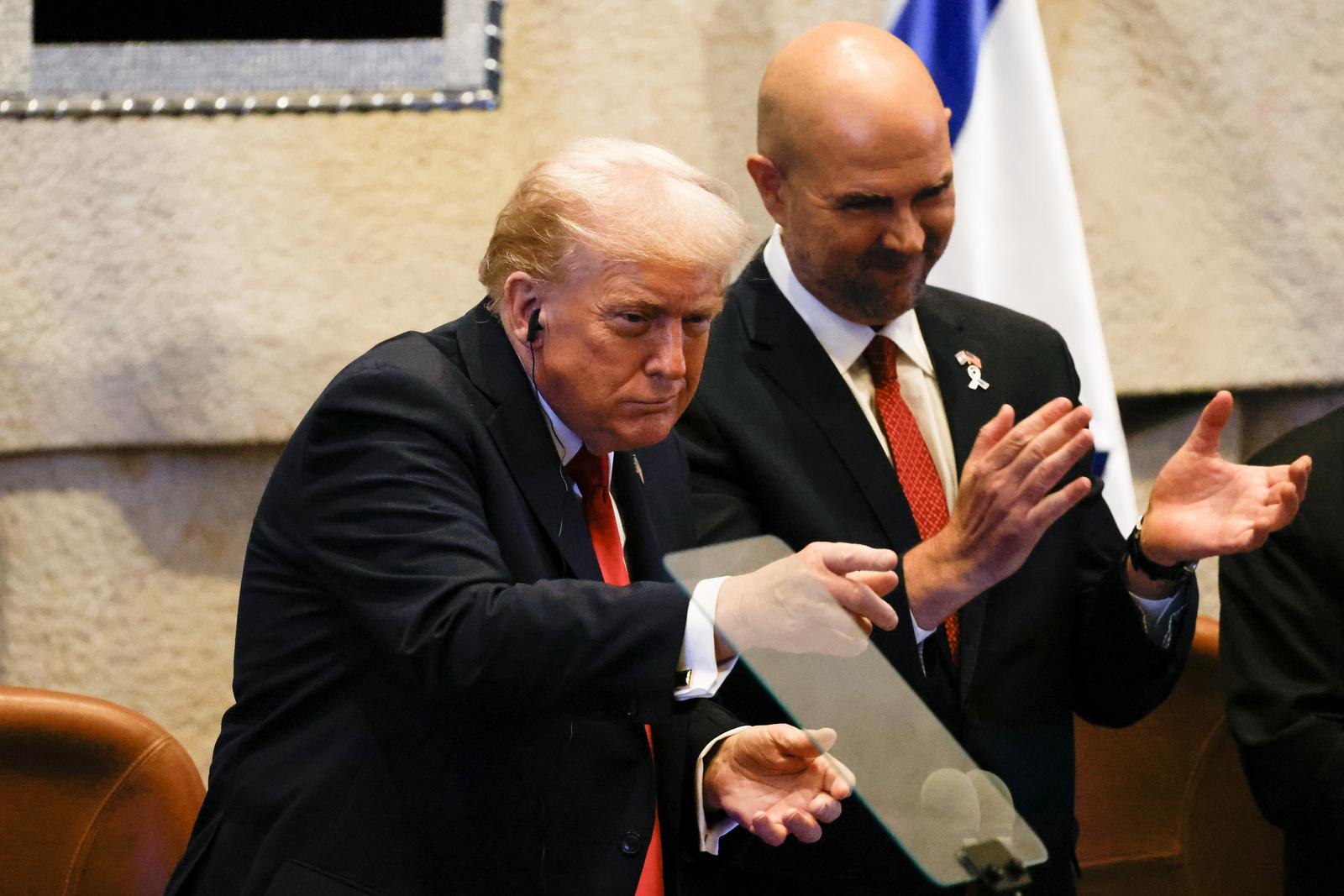 US President Donald Trump (L) reacts next to Amir Ohana, Speaker of the Israeli Knesset, during the Israeli parliament, the Knesset, in Jerusalem on Monday, October 13, 2025. Hamas handed over the 20 surviving Israeli hostages on October 13 under a ceasefire agreement, as the US president and other world leaders geared up for a summit on Gaza. The releases are part of a ceasefire agreement.   Photo by Jalaa Marey/UPI Photo via Newscom Photo: JALAA MAREY/NEWSCOM