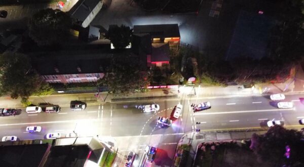 (251006) -- SYDNEY, Oct. 6, 2025 (Xinhua) -- This photo taken with a mobile phone on Oct. 5, 2025 shows police vehicles near the site of the incident in Sydney, Australia. Police in the Australian State of New South Wales said in a statement on Sunday evening that a man was taken to the hospital suffering a gunshot wound, and a number of other people have reported injuries. Australian Broadcasting Corporation (ABC) reported that police told the ABC that multiple gunshots were fired. (Photo by Wang Yu/Xinhua) Photo: Ma Ping/XINHUA