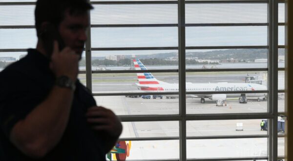 (251011) -- ARLINGTON, Oct. 11, 2025 (Xinhua) -- A man makes a phone call at Ronald Reagan Washington National Airport in Arlington, Virginia, the United States, on Oct. 10, 2025. The U.S. federal government shutdown has led to flight delays, as essential employees such as air traffic controllers and Transportation Security Administration (TSA) officers are working without pay. That has led to staff shortages. (Xinhua/Li Rui) Photo: Li Rui/XINHUA
