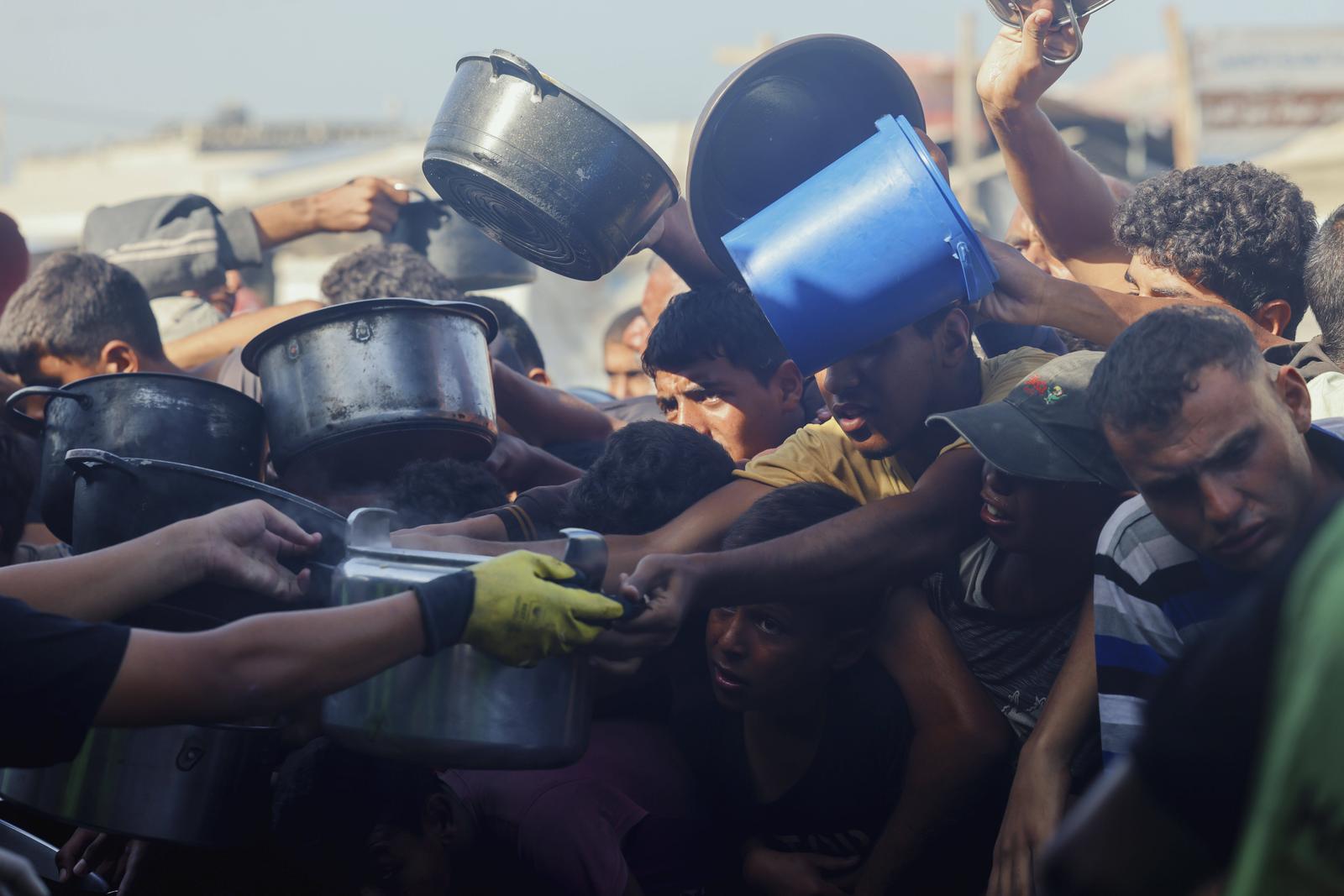 Displaced Palestinians wait in long lines for a charitable meal under crowded tents in Khan Yunis, Gaza, on October 21, 2025, as food scarcity worsens under the ongoing siege. Women and children rely on small charity kitchens to feed thousands amid a daily struggle for survival.//MIDDLEEASTIMAGES_MEI21693/Credit:Abdolrahman Rashad/MEI/SIPA/2510220839 Photo: Abdolrahman Rashad/MEI/SIPA/SIPA PRESS